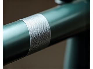 Reflective tape applied along a bike frame tube, enhancing side visibility